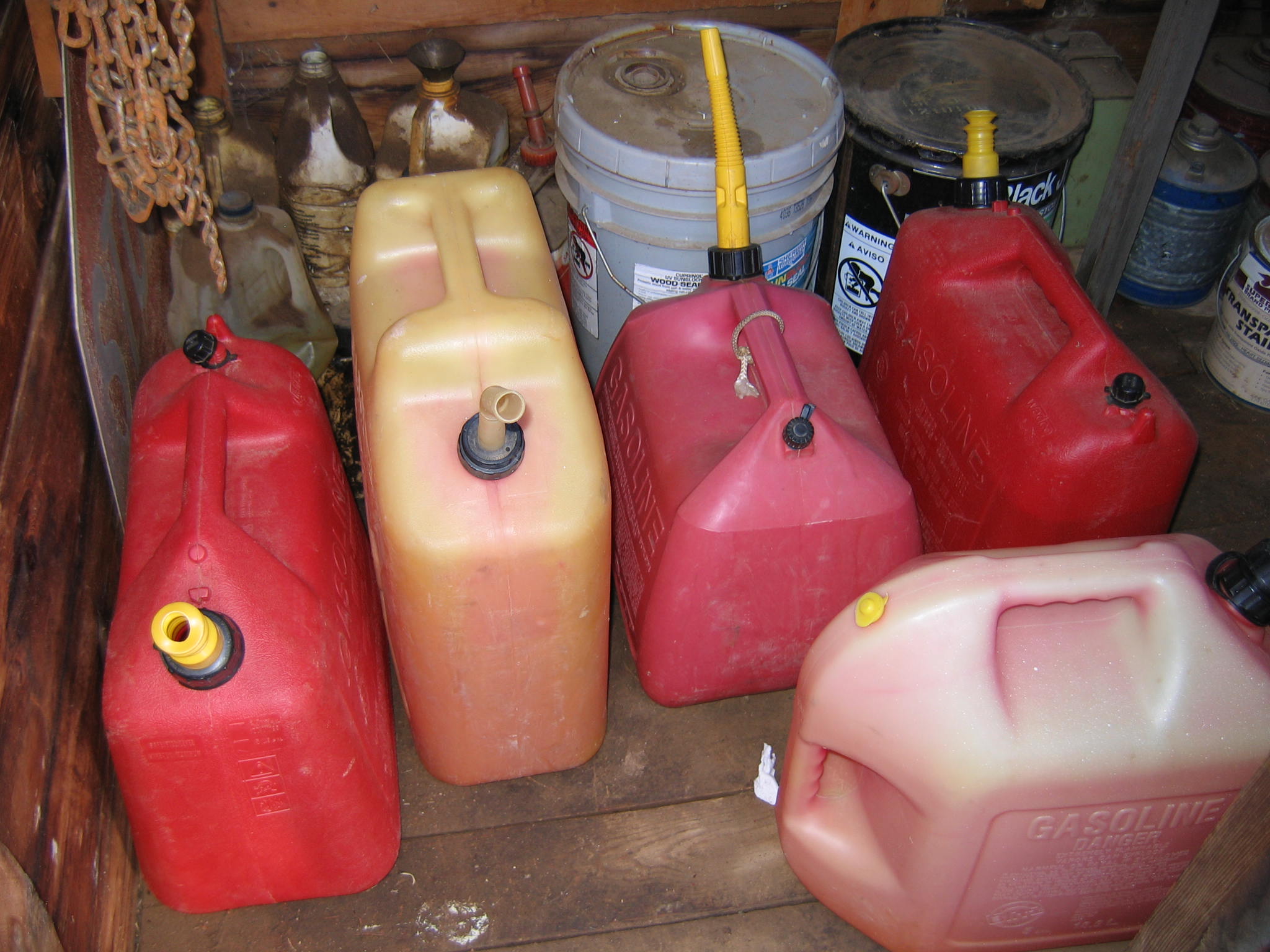 improper flammable liquid stored in unapproved containers and no flamm locker