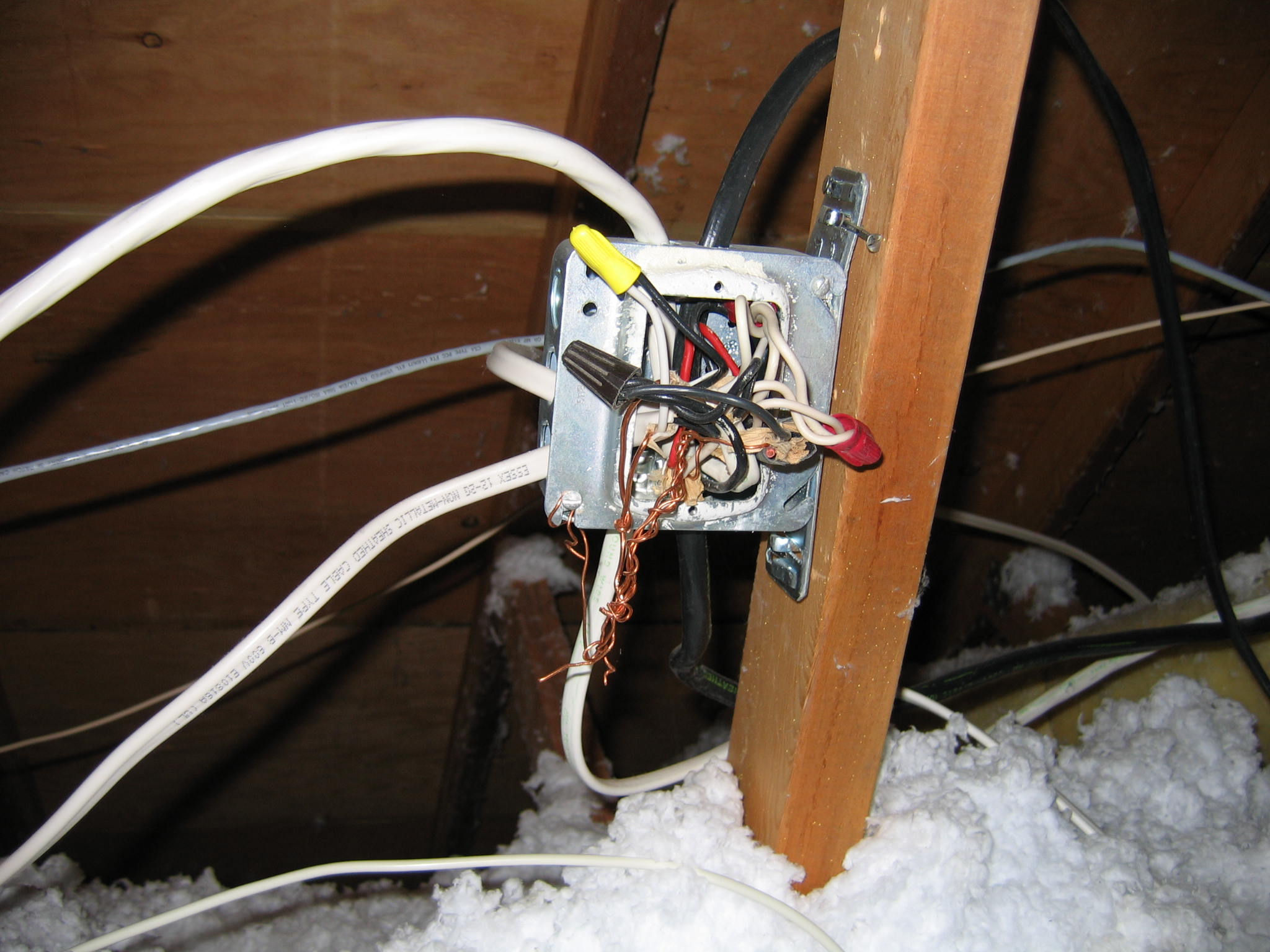 Electricl junction box in attic with exposed wiring not properly closed